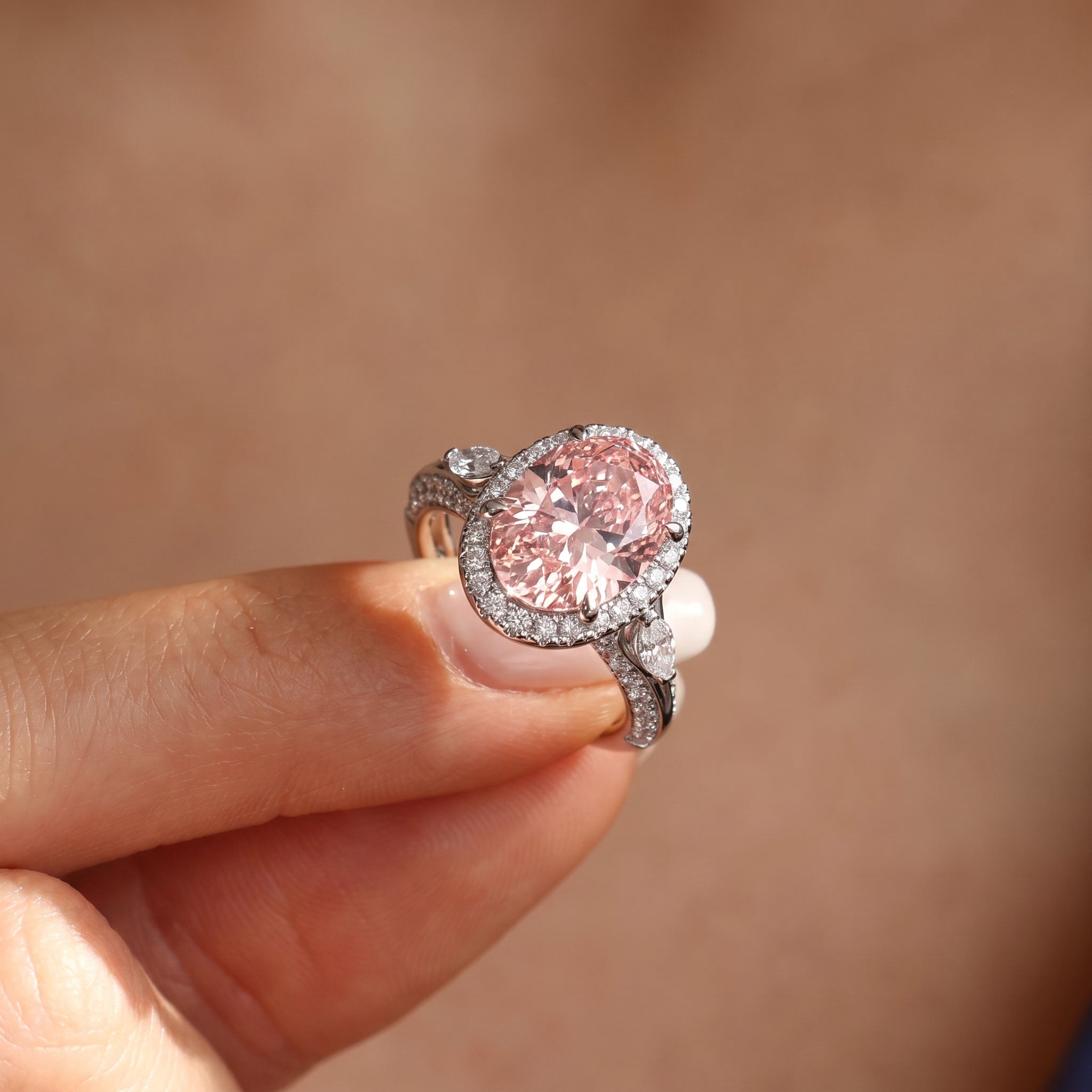 3Cttw Oval Shaped Pink Lab Grown Diamond (F/VS) Three Stone Halo Engagement Ring in 14K Gold